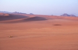 wilderness-camping;safier-farm;namib-desert;namibia;africa;flat;plain;plains;slope;truck;small;miniature;sand-dune;sand-dunes;rock;rocks;sparse;empty;bare