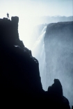 on-the-edge;Victoria-Falls;Zimbabwe;Zambia;southern-Africa;african;silhouette;silhouettes;waterfall;waterfalls;africa;zambezi-river;zambesi;zambeze;rivers;power;alone;solo;top;atop;cliff;cliffs;bluff;bluffs;danger;dangerous;high;person;people;mist;misty;adventure;excite;exciting;heights