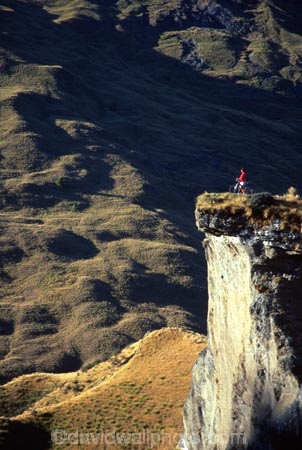 Queenstown;Central-Otago;Skippers-Canyon;canyon;mountain-biker;mountain-bike;mountain;mountains;rocks;rocky;rock;grassy;adventure;green;distant;cliff;shadow;shadowy