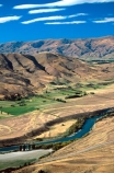 rivers;landscape;agriculture;rural;farming;farms;farm-blocks;block;land;landscape;hill;range;mountain;mountain-range;cultivated;Clutha;winding;curve;curving;river-course;dry;central-otago;arid;irrigation;field;fields;paddock;paddocks;meadow;meadows