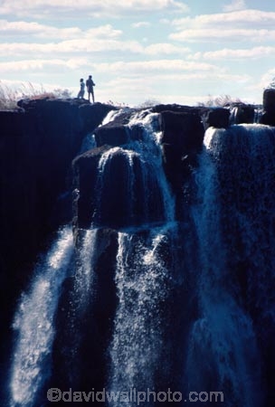 on-the-edge;Victoria-Falls;Zimbabwe;Zambia;southern-Africa;african;silhouette;silhouettes;waterfall;waterfalls;africa;zambezi-river;zambesi;zambeze;rivers;power;alone;solo;top;atop;cliff;cliffs;bluff;bluffs;danger;dangerous;high;person;people;mist;misty;adventure;excite;exciting;heights