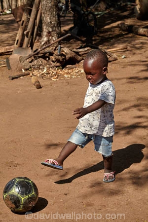 Africa;African;African-boy;ball;balls;boy;boys;child;children;football;footballs;kick;kicking;kicks;Matetsi;small;soccer;Southern-Africa;Zimbabwe