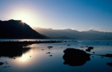 lake;lake-wanaka;reflection;still;stillness;water;tranquil;tranquility;peaceful;calm;sunrise;haze;hazy;sun-ray;sun-rays;sun-beam;sun-beams;silhouette;silhouettes;silhouetted